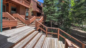 A wooden deck with stairs leading to a building with multiple balconies. - Superb 4-bedroom condo with AC in quaint Brian Head steps from Giant Steps Lodge (Brian Head)