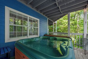 A hot tub on a wooden deck with a covered area, surrounded by trees. - Quiet 4BR w/Hot Tub*Game Room*Chalet Village*Ober (Gatlinburg)