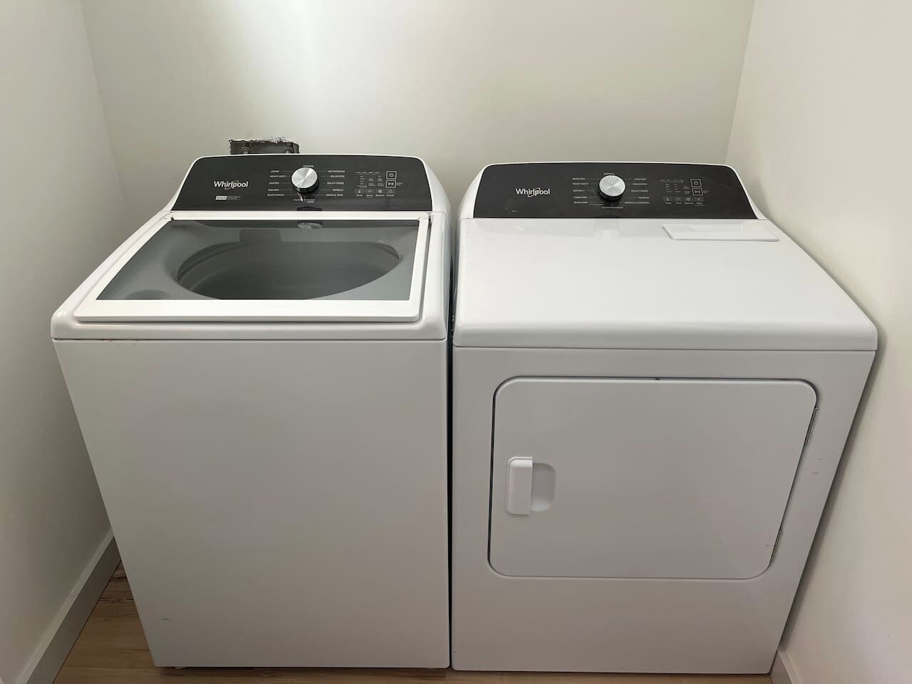 Lavadora y secadora apilables, compactas, de color blanco y con dos puertas, con panel de control en la parte superior.