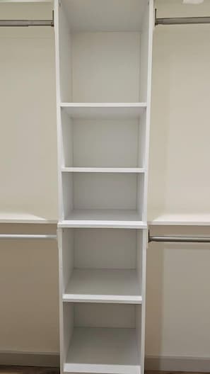 A white shelving unit with four shelves, likely used for storage. - New Massage Chair / Clean / 3 BR / RV Pwr / Foley / Yard 124 (Foley)