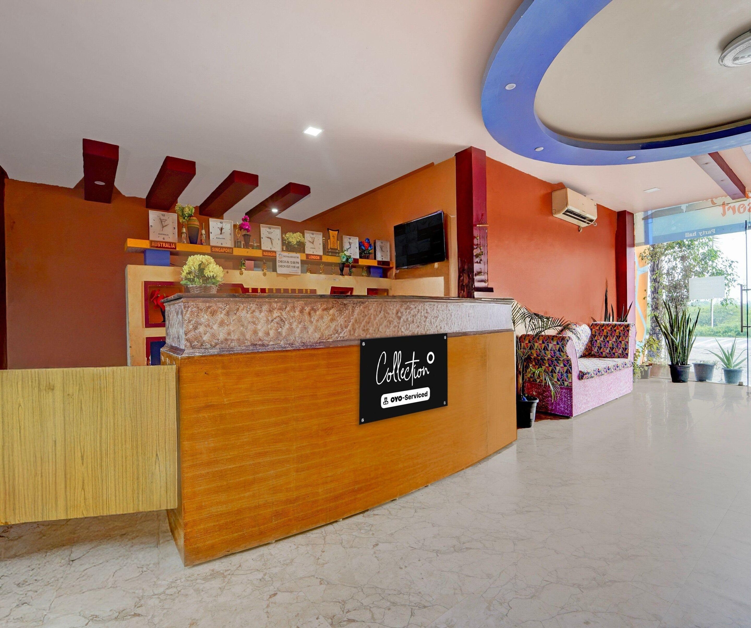 A reception desk with a sign indicating 'Collection' and 'OYO-Serviced'.
