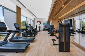 A modern gym with treadmills, stationary bikes, and weight machines. - Elegant 2BR at VidaDubai Mall Prime Downtown Location (Dubai)