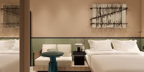 A hotel room with a bed, a sofa, a small table, and a wall-mounted lamp. - Motto By Hilton Shanghai Wuliqiao (Shanghai)