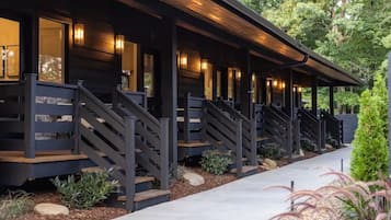 A modern building with multiple staircases leading to a covered porch area.