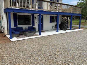 A building with a covered porch, outdoor seating, and a staircase leading to an upper level. - Flip-Flop down to the Lake; Cozy 2-bedroom apartment with AC (MOORESVILLE)