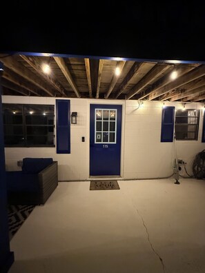 A blue door with the number 115, a white wall, and a wooden ceiling with exposed beams. - Cozy 2-bedroom apartment with AC in charming Mooresville (MOORESVILLE)