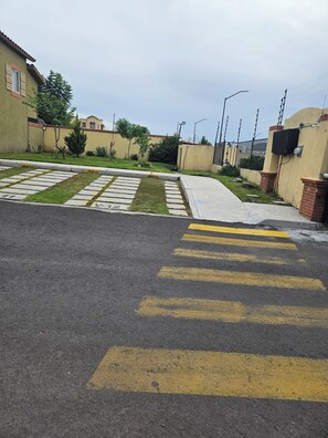 A parking area with marked spaces and a pedestrian crossing.