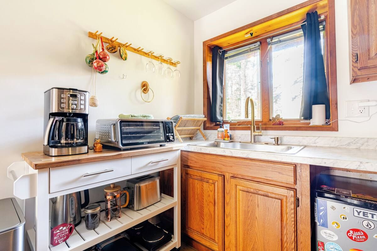 A compact kitchen with a coffee maker, toaster, and oven.