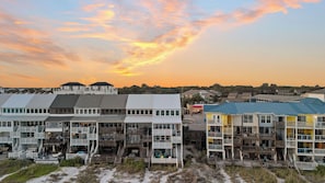 A coastal residential area with multi-story buildings featuring balconies and outdoor seating areas. - Seawinds 1 by Avantstay Beachfront + Private Beach + Daily Chair Service + 3 Decks (Miramar Beach)
