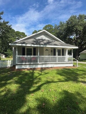 A single-story house with a porch and a fenced yard. - Minutes to Beaches • Self Check-In • Fully Remodeled • Screened Porch • Cozy Fireplace • Washer & Dryer (Wilmington)