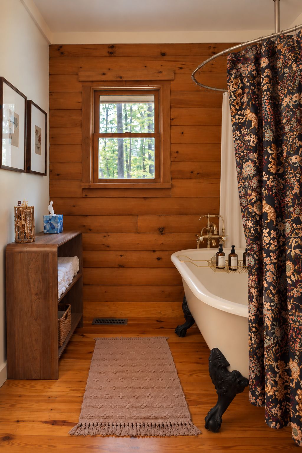 A bathroom with a wooden wall, a window, a bathtub, a shower curtain, and a shelf with towels.