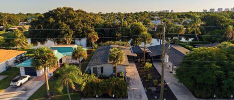 A residential area with houses, a swimming pool, and a clear view of the surrounding landscape.
