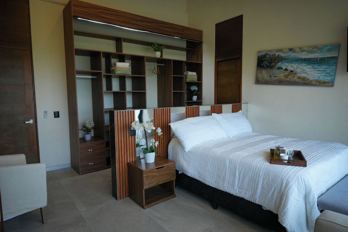 A bedroom with a bed, bedside table, and a built-in wardrobe.