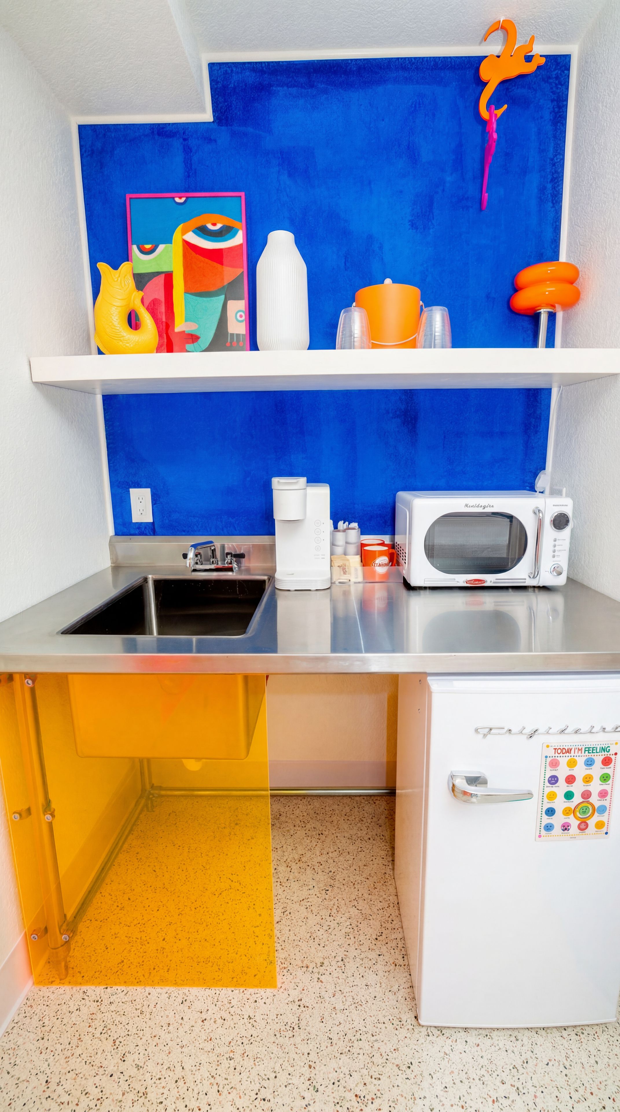 A compact kitchen with a sink, a microwave, and a refrigerator.