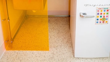 A compact kitchen with a sink, a microwave, and a refrigerator.