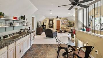 A spacious kitchen with a dining area, a ceiling fan, and a view of the outdoors.
