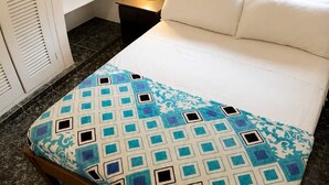 A bedroom with a bed, a nightstand, a window, and a wardrobe. - Sea View | Hot Tub | Steps to Beach (Atacames)