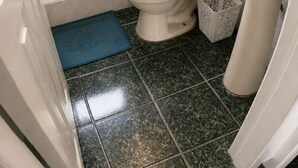 A compact bathroom with a shower, toilet, and sink. - Sea View | Hot Tub | Steps to Beach (Atacames)