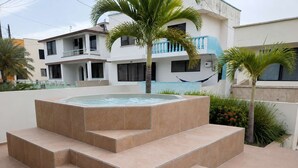 A hot tub with steps leading up to it, surrounded by a tiled patio area. - Sea View | Hot Tub | Steps to Beach (Atacames)