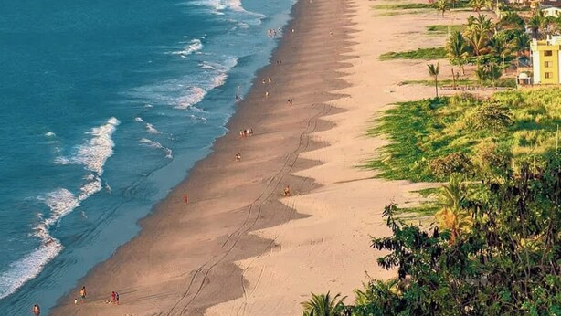 A coastal cityscape with a wide sandy beach, a clear blue sea, and a dense urban area with high-rise buildings. - Sea View | Hot Tub | Steps to Beach (Atacames)