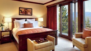 A hotel room with a large bed, two bedside tables, a chair, a small table with a tray, and a balcony with a view. - Experience Luxury and Family Fun at The Ritz-Carlton Club, Lake Tahoe- 3 Bd. Res (Truckee)