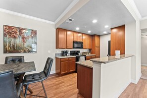 Fully stocked kitchen with dining space—ideal for cooking, working, or gathering over a meal. - South Reno 1BR Near Reno Events, Pool, Hot Tub, & Gym (Reno)