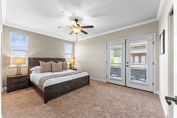 Rest easy in this spacious, sunlit bedroom with direct patio access and a luxurious bed. - South Reno 1BR Near Reno Events, Pool, Hot Tub, & Gym (Reno)