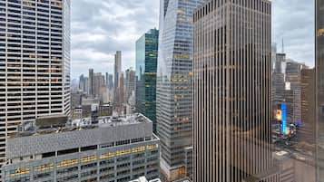 A cityscape with modern high-rise buildings, including a building with a distinctive vertical pattern and another with a reflective glass facade.