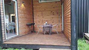 Covered deck with table, chairs and BBQ grill