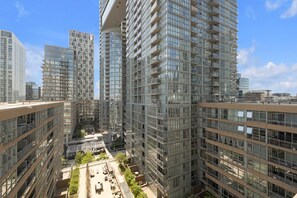 A high-rise residential building with multiple balconies and a central courtyard. - Sleek Downtown Oasis  Modern Retreat in Toronto | Parking Available (Toronto)