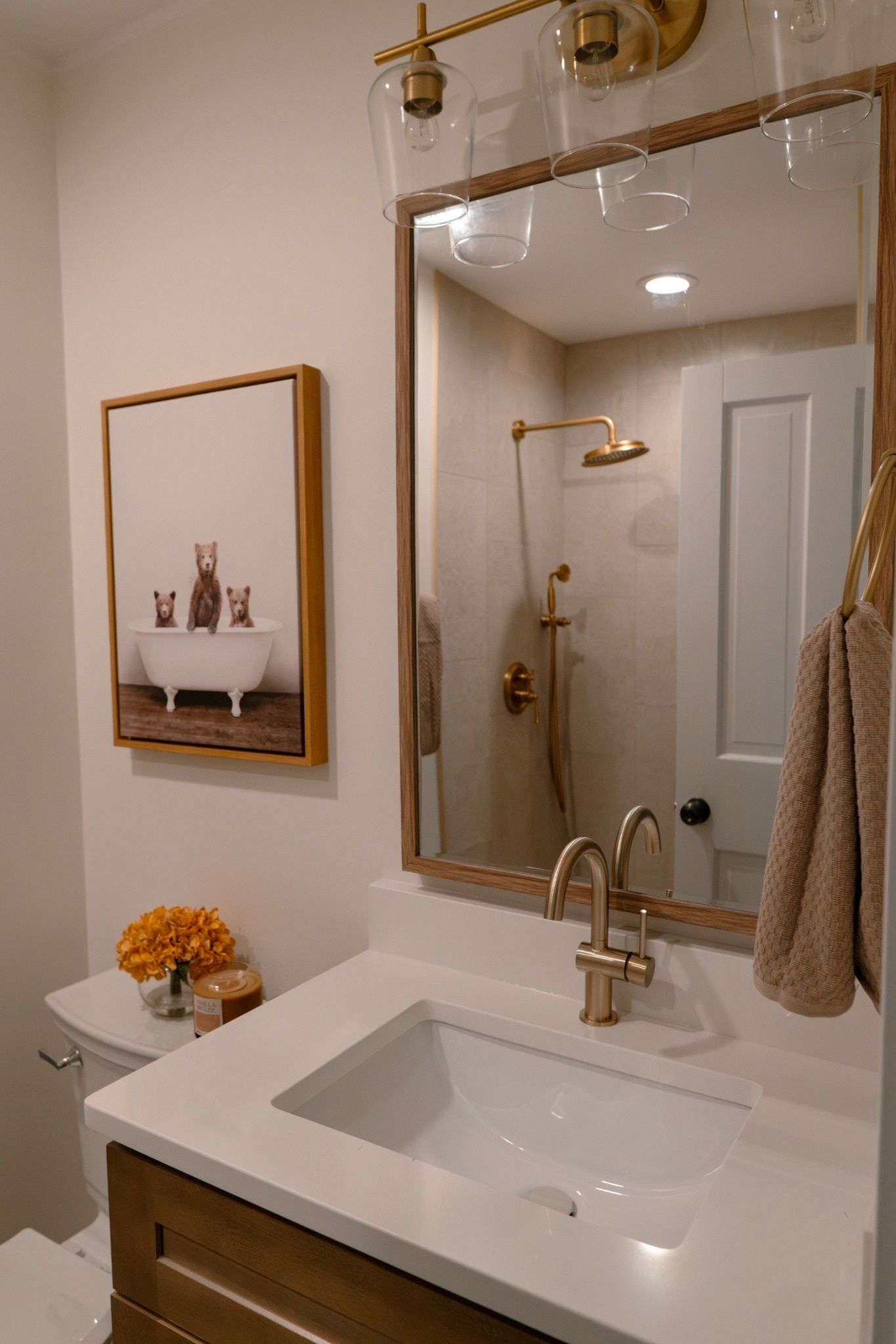 A bathroom with a large mirror, a bathtub, a shower, and a sink.