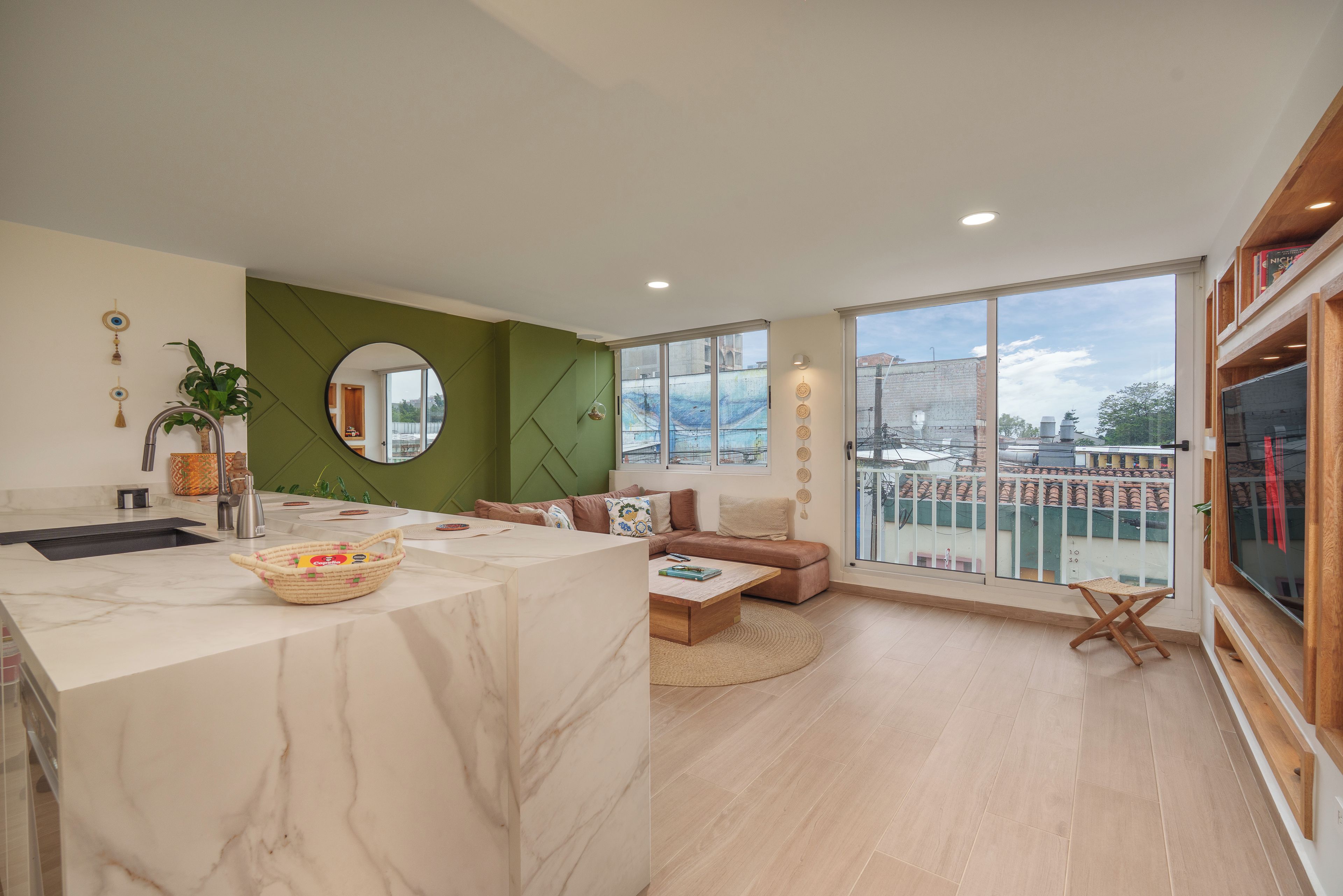 A modern apartment with a kitchen, living area, and balcony.