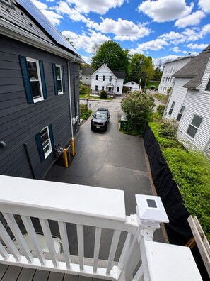 A residential street with houses, a driveway, and a parked car. - Fitchburg hideaway Home (Fitchburg)