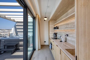 A modern kitchen with a built-in oven, a coffee machine, and a sink. - One of a king Top-Floor, Jacuzzi Terrace - Mercury (St. Julian`s)