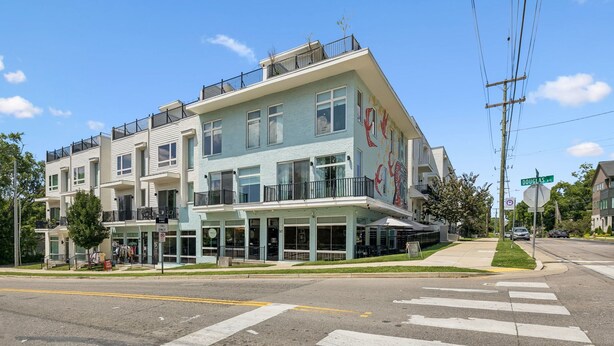 A multi-story building with a ground-level commercial space and upper residential units. - Furnished Monthly- 3BR Rooftop- East Nashville (Nashville)