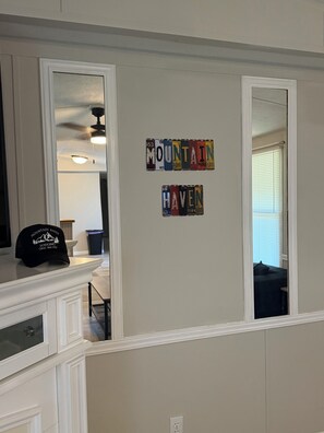 A room with a white wall displaying a collection of license plates spelling 'MOUNTAIN HAVEN.' - Luxury Mountain Retreat ~ Ride-In/Ride-Out ATV/UTV Access (Rock)