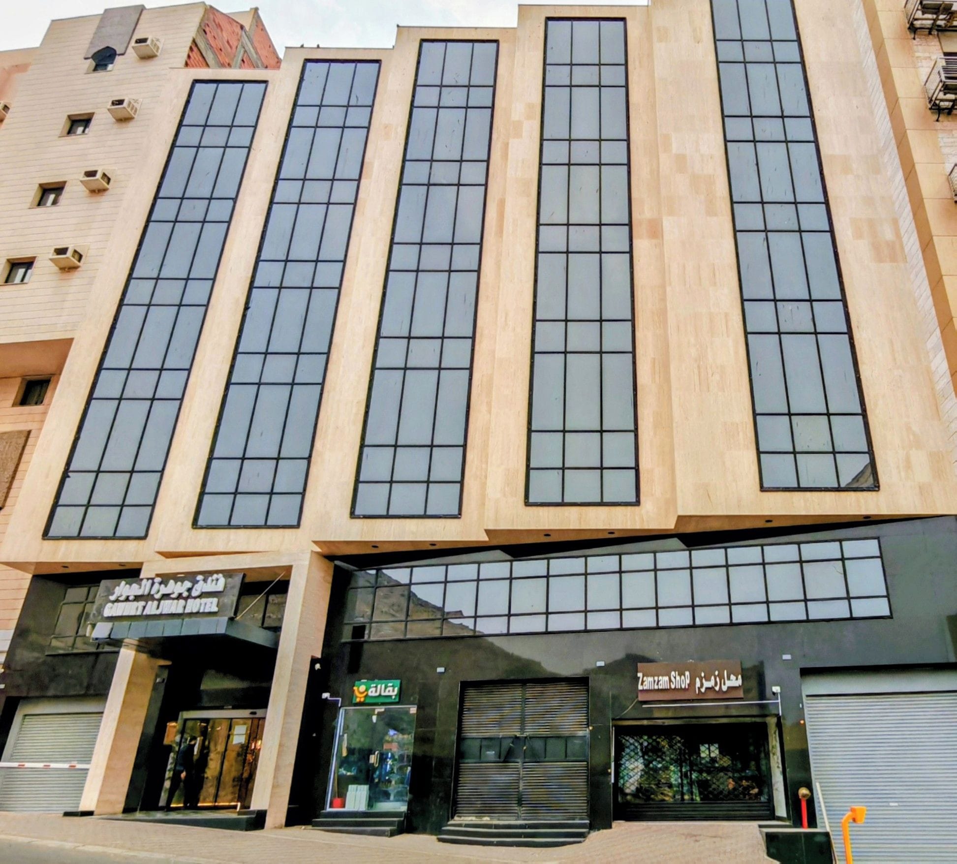 A multi-story building with large windows and a flat facade.