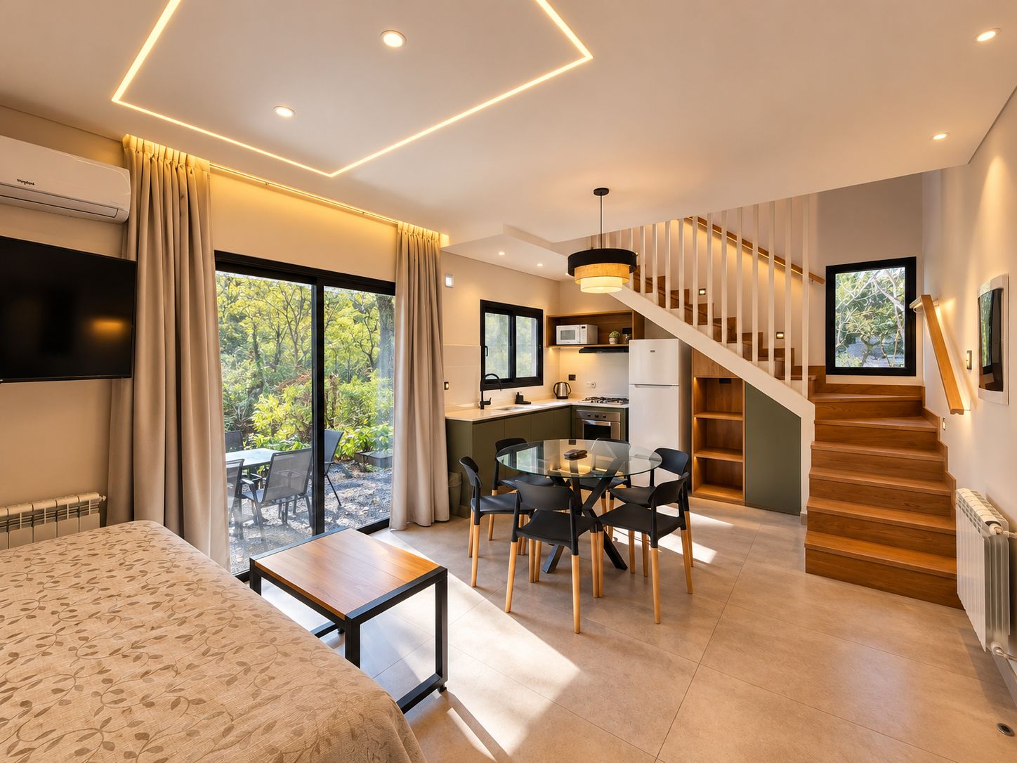 A modern interior with a dining area, kitchen, and staircase.
