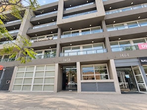 A multi-story building with numbered windows, a garage entrance, and a visible storefront.