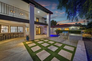 A two-story house with a balcony, outdoor seating, and a barbecue area. - The Scottsdale Compound: Pool, Putt, Play, Repeat (Scottsdale)