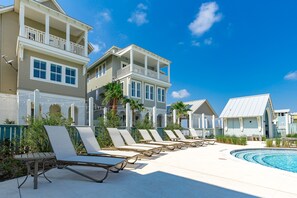 A poolside area with lounge chairs and a pool. - Palmilla Beach Resort-137 Palmilla Circle Unit 302 (Port Aransas)