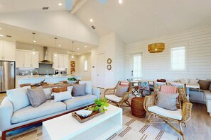 A spacious living area with a sofa, wicker chairs, and a coffee table. - Palmilla Beach Resort-103 Peppervine (Port Aransas)