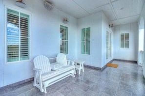 A corridor with a bench, a door, and a window with shutters. - Palmilla Beach Resort-128 Cattail Lane (Port Aransas)