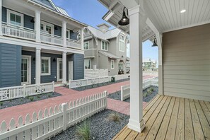 A multi-story residential building with a covered porch and a wooden deck. - Palmilla Beach Resort-131 Sabal Lane (Port Aransas)