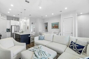 A modern kitchen with a central island, white cabinetry, and stainless steel appliances. - Palmilla Beach Resort-166 Spanish Dagger Lane (Port Aransas)
