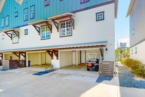 A multi-story residential building with a garage and a covered parking area. - Palmilla Beach Resort-169 Spanish Dagger Lane (Port Aransas)