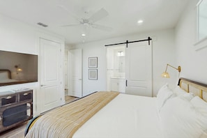 A bedroom with a bed, a ceiling fan, a TV, and a bedside lamp. - Palmilla Beach Resort-170 Spanish Dagger Lane (Port Aransas)