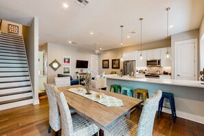 A modern kitchen with white cabinets, a stainless steel refrigerator, and a microwave. - Palmilla Beach Resort-171 Stargrass Lane (Port Aransas)