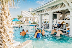 A pool area with a bar and lounge chairs. - Palmilla Beach Resort-171 Stargrass Lane (Port Aransas)