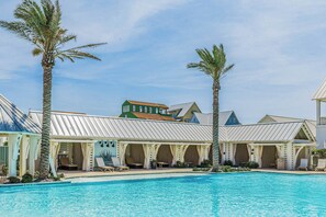 A resort with a swimming pool, lounge chairs, and palm trees. - Palmilla Beach Resort-172 Spanish Dagger Lane (Port Aransas)